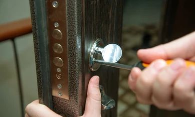 man-fixing-door-screwdriver-lock-260nw-1418739497.jpg